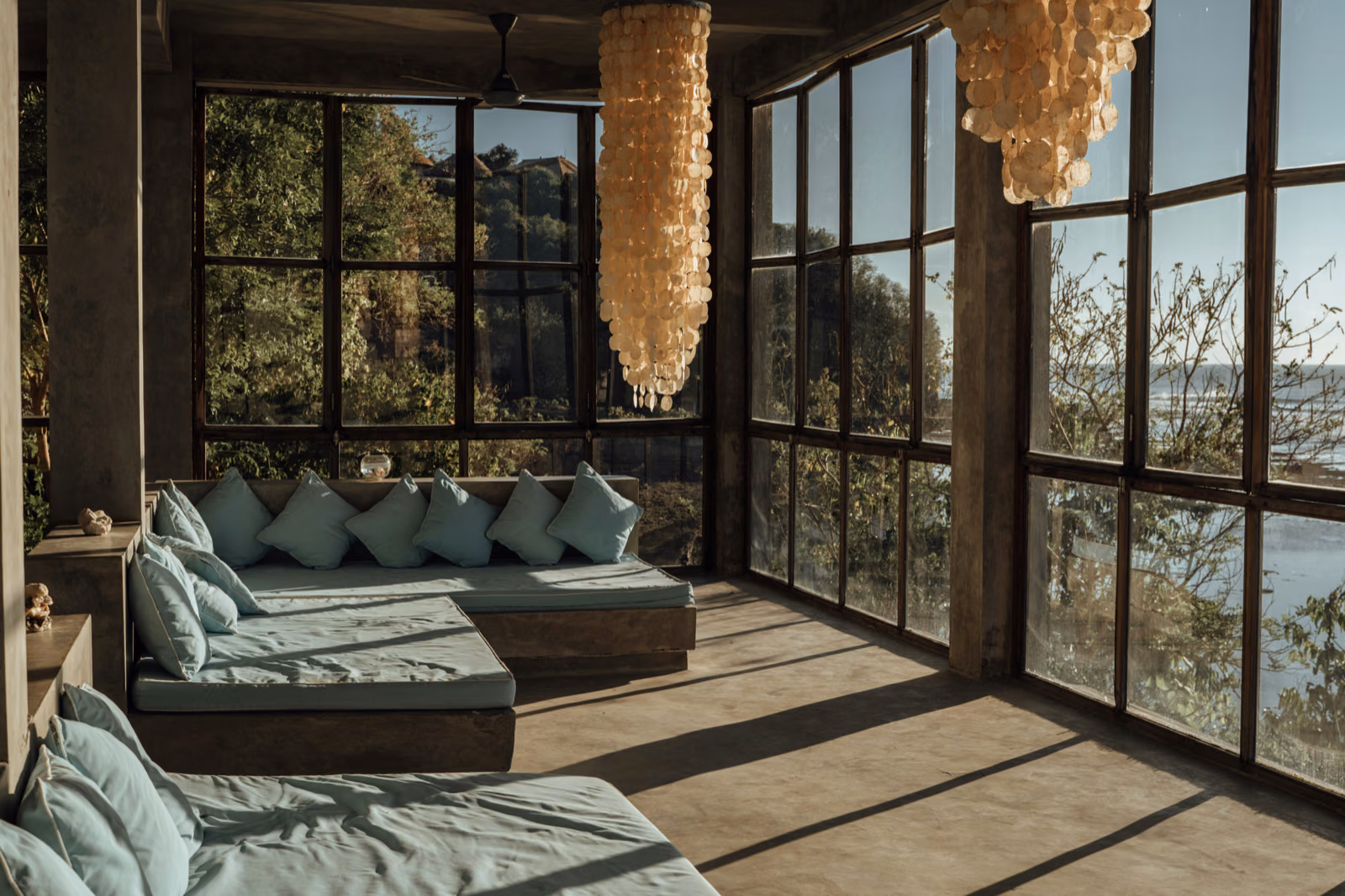 a beautiful sunroom with floor-to-ceiling windows and a stunning natural view.
