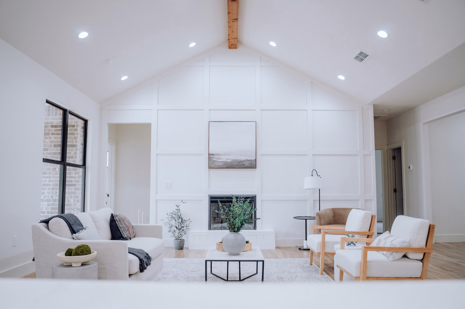 A warm, inviting interior of a remodeled home, illuminated by natural light streaming through large windows.