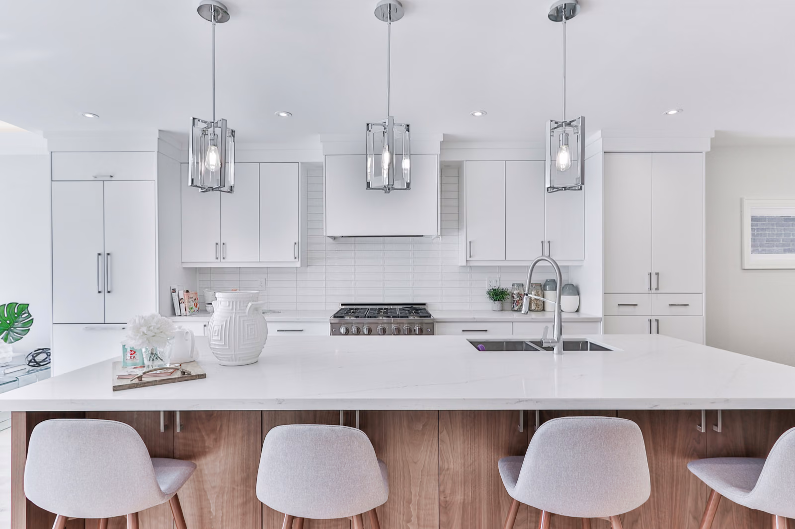 A modern, well-lit kitchen with sleek, Renotive brand cabinets in a warm, wood-grain finish. The cabinets feature minimalist handles and ample storage space. A large, double-hung window floods the room with natural light, casting a soft, diffused glow. The kitchen countertops are a complementary quartz or granite material, providing a smooth, clean work surface. Stainless steel appliances gleam, blending seamlessly with the overall aesthetic. The floor is a durable, hardwood or tile in a neutral tone. The scene conveys a sense of organization, efficiency, and contemporary style.