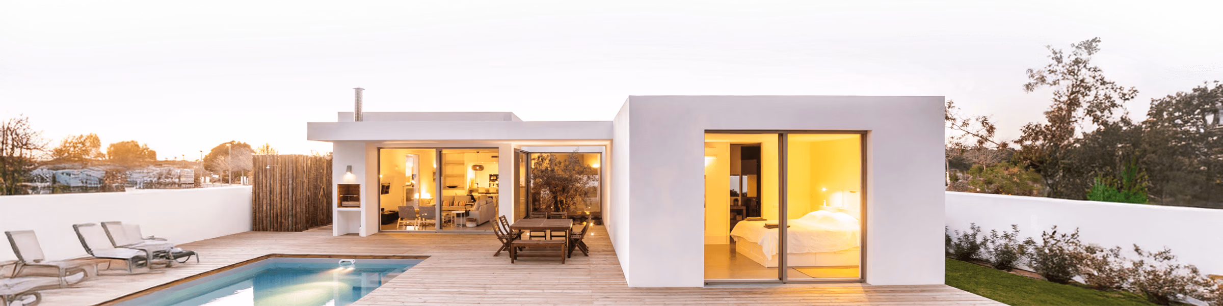 Modern home with a pool at dusk